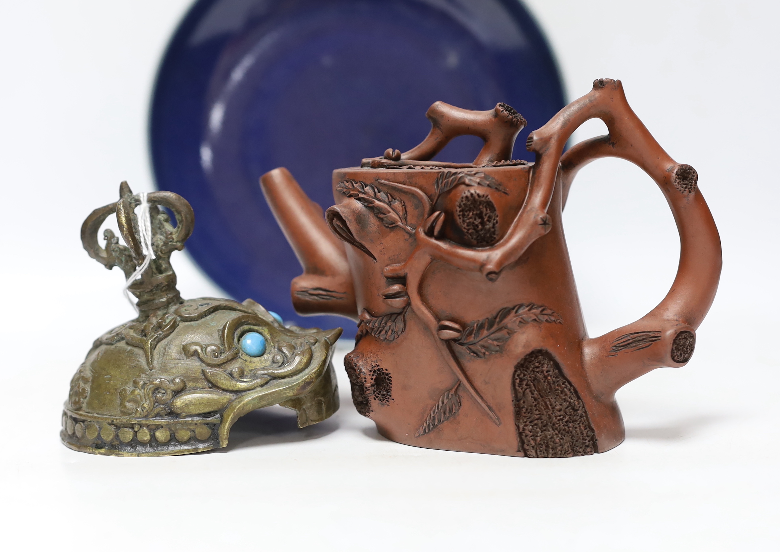 A Chinese Yixing ‘tree branch’ teapot, 13cm, A 20th century Tibetan kapala cover, 9cm and a Chinese blue glazed dish, Yongzheng mark but later, 22.5cm diameter